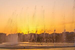 groot fonteinen Aan de kunstmatig vijver, verlichte door zonlicht Bij zonsondergang in Tasjkent stad park Bij zomer. foto