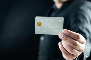 zakenman in pak tonen een credit kaart foto
