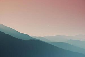 een berg reeks met een zonsondergang in de achtergrond foto