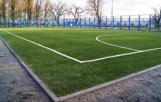 groen kunstmatig grasmat Amerikaans voetbal veld- in de park. wit markeringen. foto
