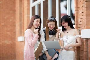 Aziatisch jong campus leerling genieten leren studie en lezing boeken samen. vriendschap en onderwijs concept. campus school- en Universiteit. geluk en grappig van aan het leren in college foto