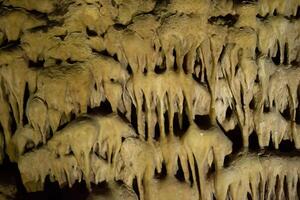 de grot is karst, verbazingwekkend visie van stalactieten en stalagnieten verlichte door helder licht, een mooi natuurlijk attractie in een toerist plaats. foto