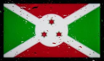 druppels water op de achtergrond van de vlag van Burundi. ondiepe scherptediepte. selectieve aandacht. afgezwakt. foto