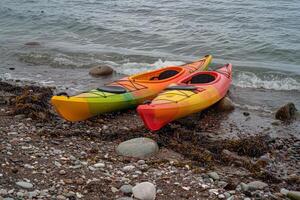 paar- van kleurrijk kajaks resting Aan de oever, wenkende avonturiers naar onderzoeken verborgen baaien foto
