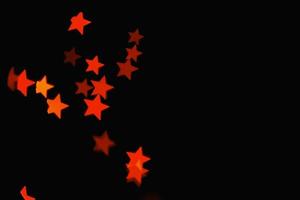 licht oranje ster lichteffect geïsoleerde overlay glitter textuur op zwart. foto