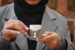 vrouw drinken Turks koffie Bij cafe foto