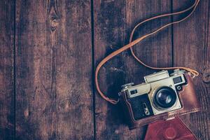 oud retro wijnoogst camera Aan grunge houten achtergrond foto