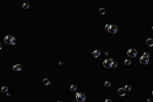 transparante bubbels zeep patroon overlay abstracte deeltjes spatten van water op zwart. foto