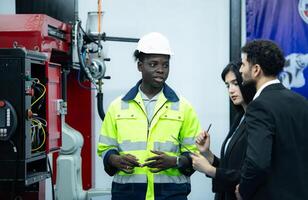 technici zijn introduceren industrieel hand- robots naar zakenman van fabriek industrie wie zullen gebruik hen in grootschalige complex fabricage activiteiten. foto