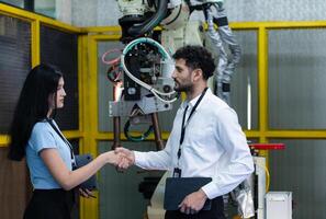 bedrijf partner beven handen terwijl inspecteren Aan industrieel machine in fabriek foto