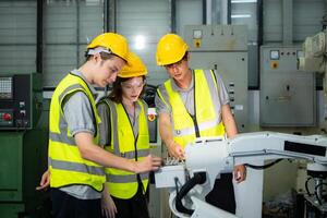 ingenieur en technicus bespreken de robot arm in fabriek over werk werkend, onderhoud en reparatie foto