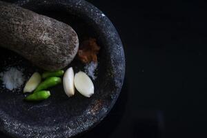 dichtbij omhoog van een keuken gereedschap in de het formulier van een steen blender gebeld cobek foto