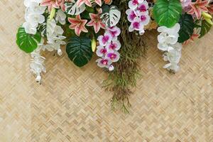 bamboe geweven matten zijn versierd met mooi kleurrijk plastic bloemen. gebruikt naar versieren de backdrop naar nemen afbeeldingen van divers evenementen. wie willen een natuurlijk Look. zacht en selectief focus. foto