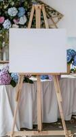 een wit blanco horizontaal poster Aan ezel in voorkant van bruiloft ontvangst tafels met pastel blauw en Purper kleuren hortensia bloemen foto