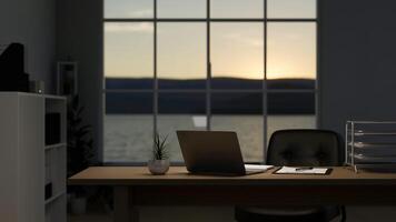 een modern privaat kantoor kamer Bij zonsondergang, een laptop computer Aan een tafel in de buurt de venster. foto