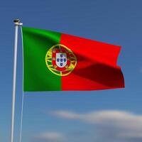 Portugal vlag is golvend in voorkant van een blauw lucht met wazig wolken in de achtergrond foto