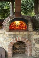 brandend brandhout in een oven, sintels, gloeiende kolen. foto