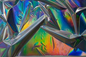 kleurrijke holografische achtergrond. moderne regenboogfolie voor textuur, omslag, behang, print, dll. donker futuristisch wazig hologram en abstracte gradiëntkleuren. foto