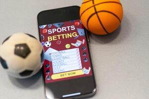 smartphone met toepassing voor sport weddenschappen en een basketbal bal, concept van online weddenschappen foto