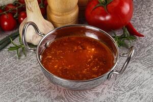heet tomaat soep met in blokjes gesneden kip foto