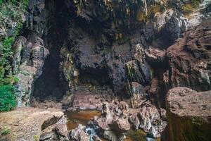de mooi keer bekeken van de stalactiet en stalagmiet gevuld grot in lam khlong ngu nationaal park, Thailand. Bij de grot Uitgang is een klein waterval Ook. foto