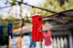 drie rood wasknijpers Aan een Kledinglijn foto