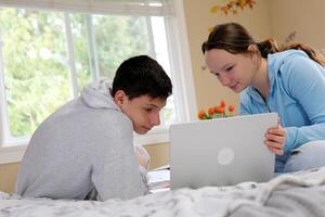 twee spaans kinderen op zoek Bij laptop foto