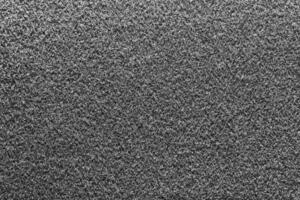 grijs wollig materiaal textuur. zwart wit gedetailleerd vezels pluizig oppervlakte achtergrond. foto