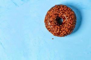 heerlijke chocolade donut op een blauwe betonnen ondergrond.