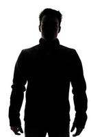mannelijke figuur in silhouet met een vest foto