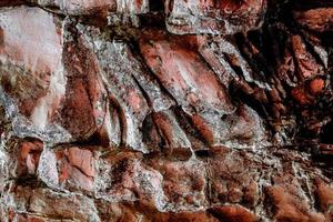 bruine rots steen textuur geïsoleerd en enorme verzameling granieten stenen achtergrond foto