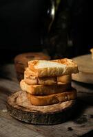 een stapel geroosterd wit brood op de houten peddel. een shot van het westers ontbijt geschikt voor reclame of presentatie. foto