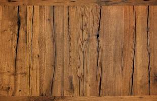 textuur en achtergrond van zeer oud gebarsten bruin hout na beschermende behandeling.