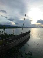 een traditionele vissersboot verankerd aan de oever van het limboto-meer, gorontalo.
