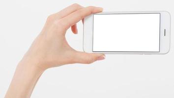 vrouwelijke hand houdt mobiele telefoon geïsoleerd op wit, vrouw met telefoon met leeg scherm, leeg scherm, aanraken foto