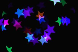 licht kleurrijke blauwe ster lichteffect geïsoleerde overlay glitter textuur op zwart. foto