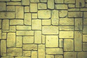 abstracte gele stenen muur realistische textuur ornament rots bouwen op natuur patroon helder. foto