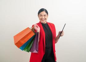 Aziatische vrouw met boodschappentas en tablet bij de hand