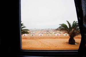 kleine huisjes aan de Namibische kust, vlakbij de namibwoestijn. uitzicht vanuit een busraam. foto