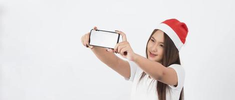Aziatische vrouw met smartphone in de hand die zich voordeed als selfie of videogesprek foto