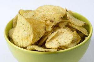 gebakken aardappelen, gecanneleerde chips op een witte achtergrond.