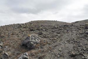 exotische rotsachtige weg naar de krater van de vulkaan. de vulkaan bevindt zich in de beroemde caldera van santorini. foto