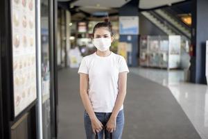 jonge vrouw met masker die buiten staat foto