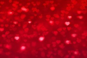 hart bokeh rode achtergrond voor Valentijnsdag wenskaart foto