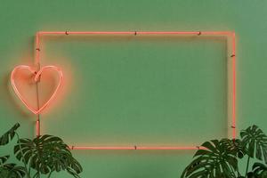 neon frame met een hart op groene muur met planten foto