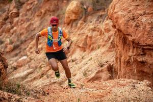 een man loper van het spoor. en atleetvoeten die sportschoenen dragen voor trailrunning in de bergen foto