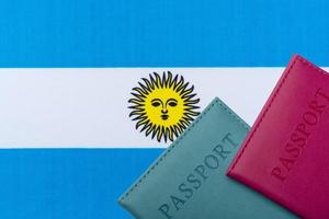 op de achtergrond van de vlag van argentinië ligt het paspoort. foto