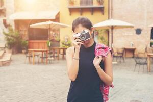 jonge mooie vrouw met retro camera, vintage retro-stijl Aziatisch meisje op vakantie gelukkig lachend. foto