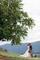 de bruid en bruidegom vieren hun huwelijk in de bergen. huwelijksfotografie. huwelijksceremonie voor twee. foto