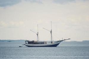 een traditioneel houten schip dat aan zee aanmeert foto